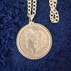 Morgan silver dollar with bezel on a 16 inch silver chain.